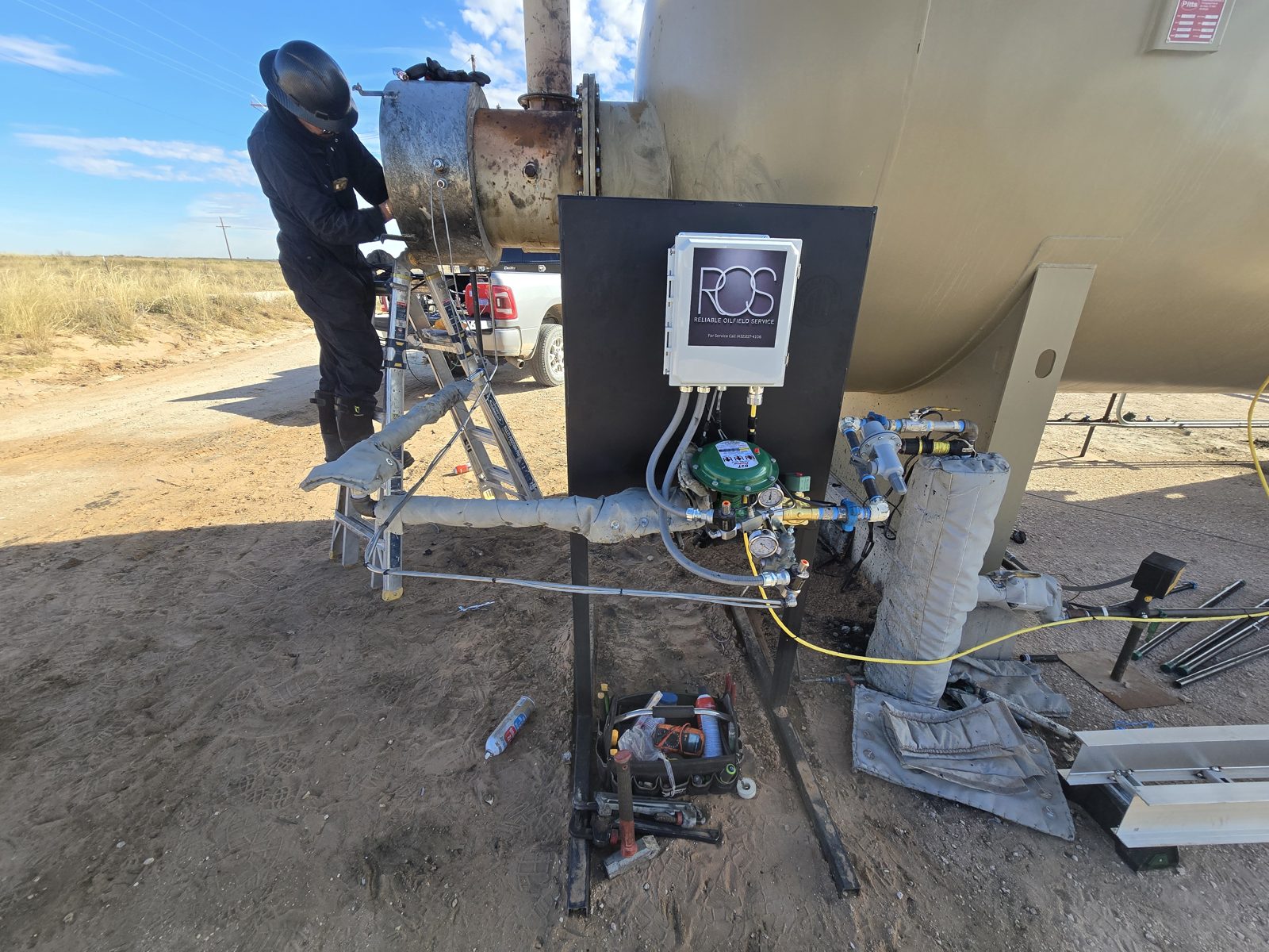 ROS technician installing a quick-connect unit at a heater treater firebox