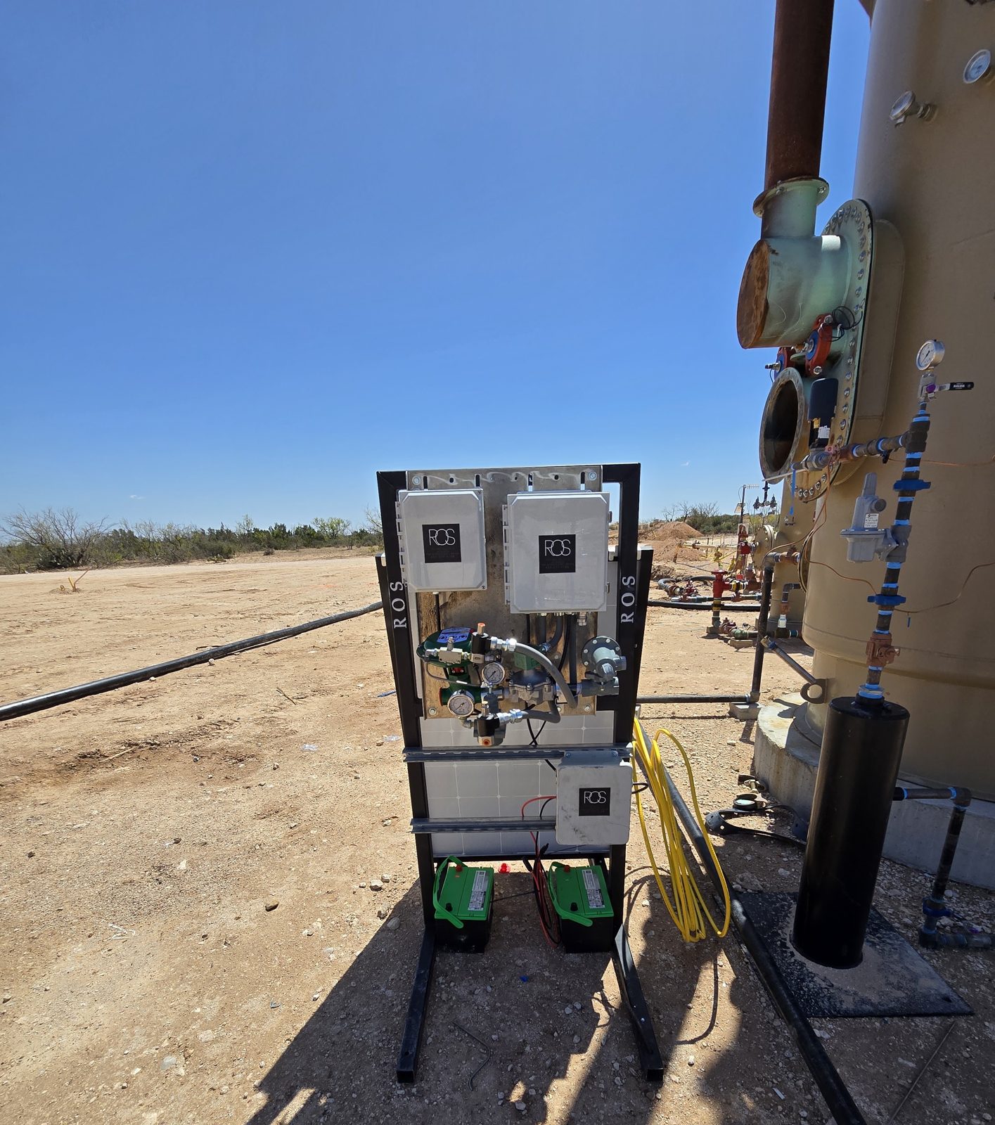 Solar-powered quick-connect unit running a heater treater on a Permian pad with no facility power